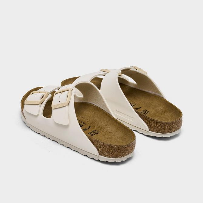 Left view of Women's Birkenstock Arizona Birkibuc Sandals (Big Kids Sizes Available) in Eggshell Click to zoom