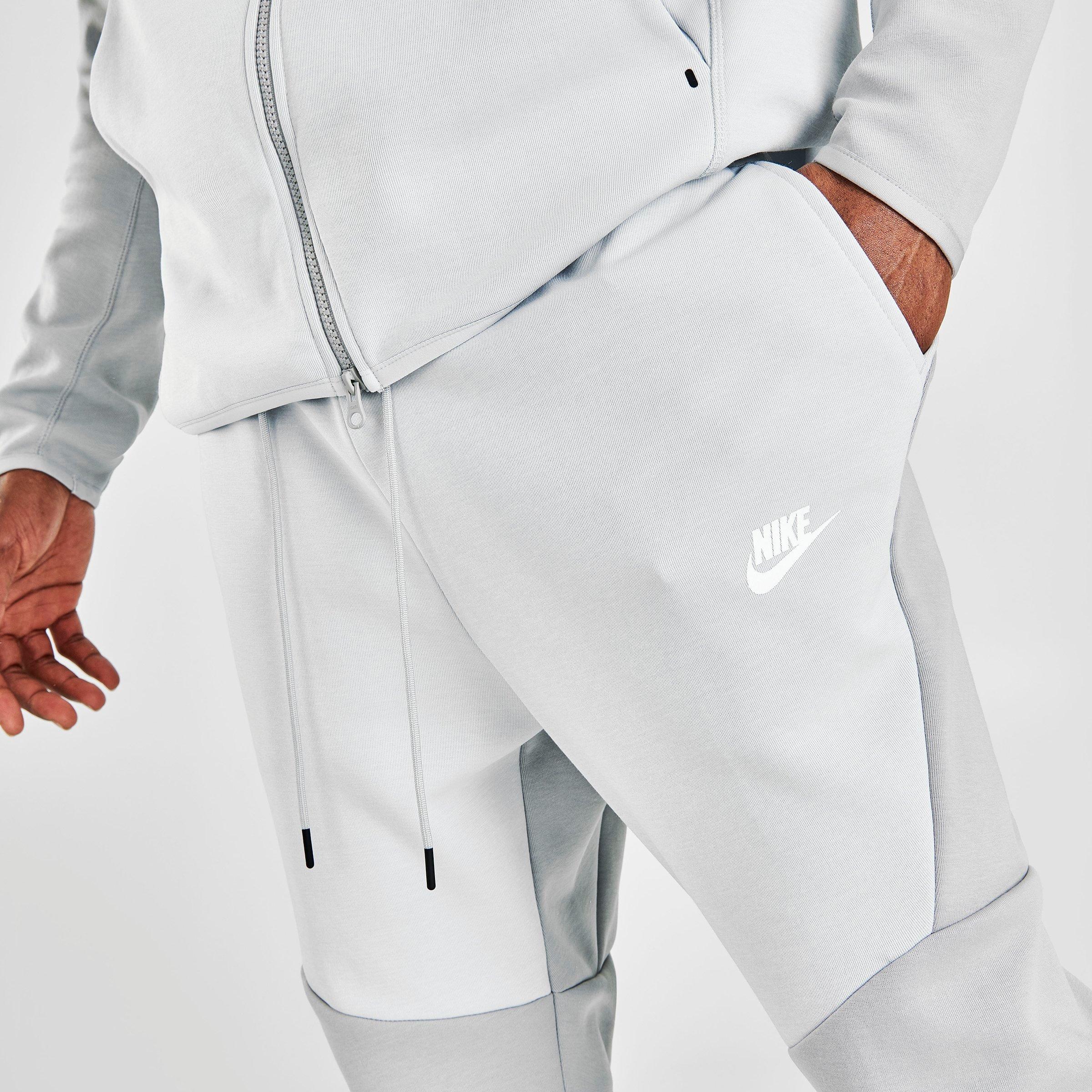 grey and white nike tech pants