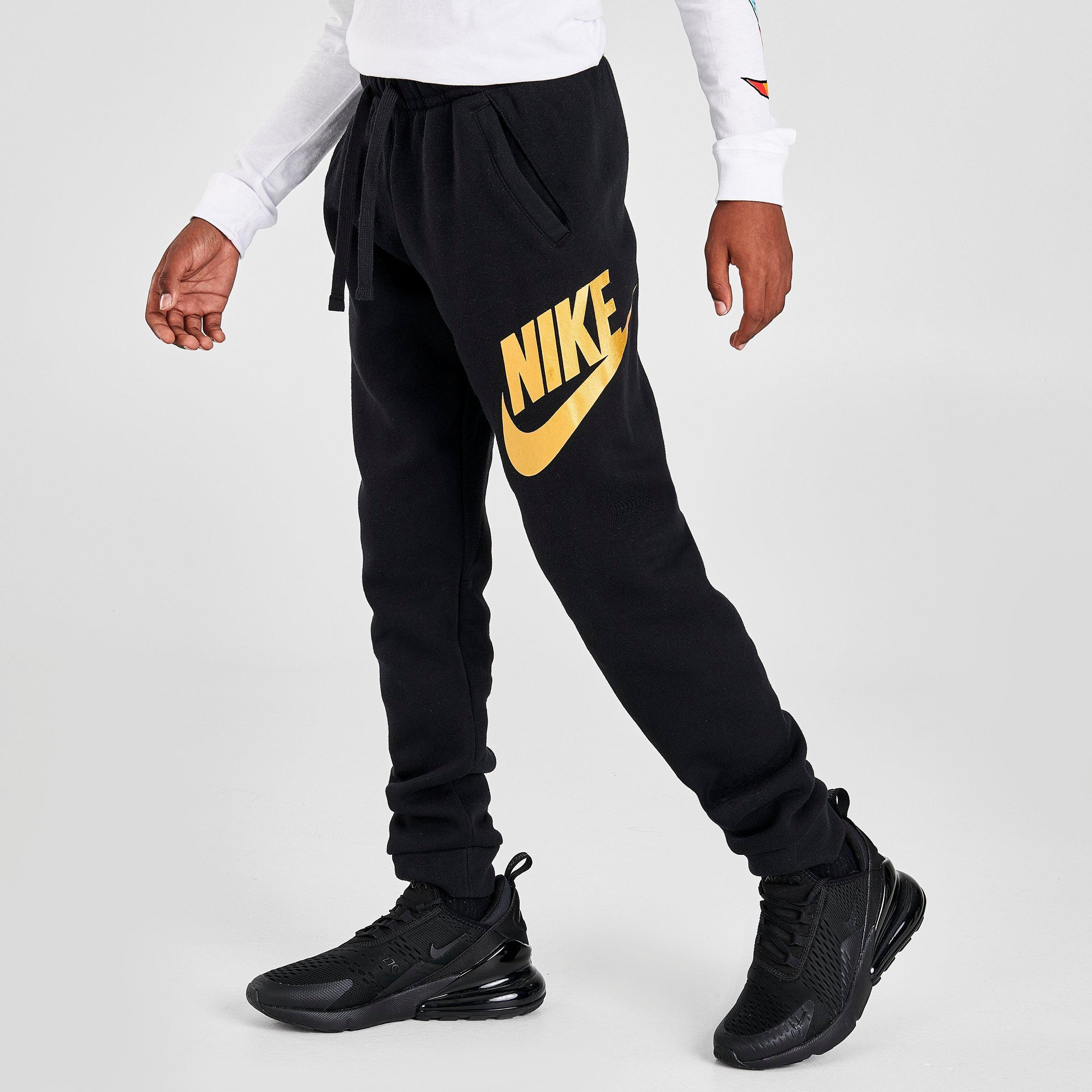 white and gold nike pants