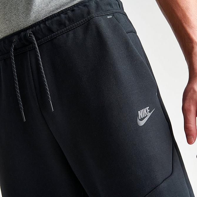 On Model 6 view of Nike Tech Fleece Taped Jogger Pants in Black Click to zoom