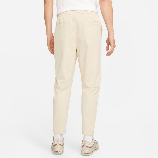 [angle] view of Men's Nike Club Woven Tapered Pants in Sanddrift/White Click to zoom