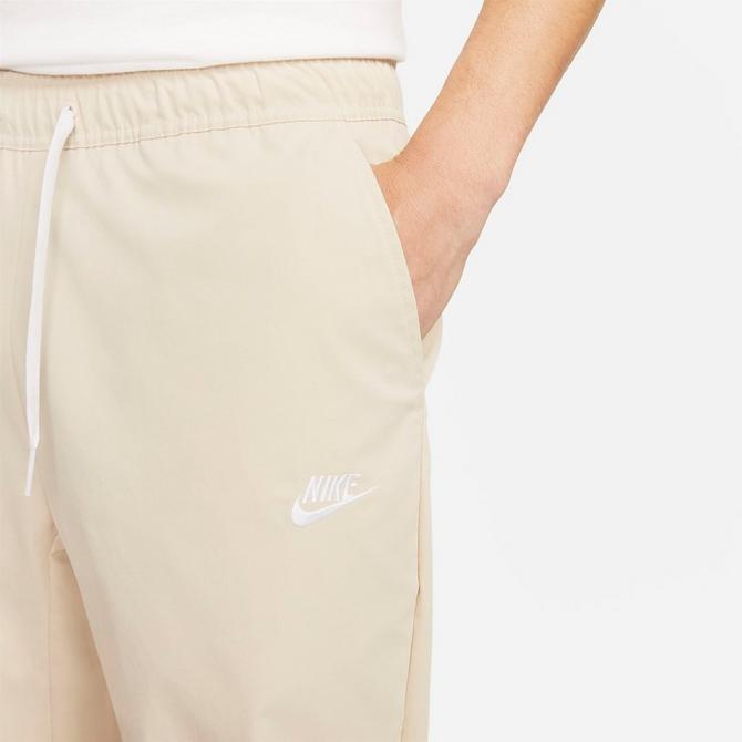 [angle] view of Men's Nike Club Woven Tapered Pants in Sanddrift/White Click to zoom