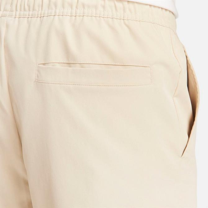 [angle] view of Men's Nike Club Woven Tapered Pants in Sanddrift/White Click to zoom