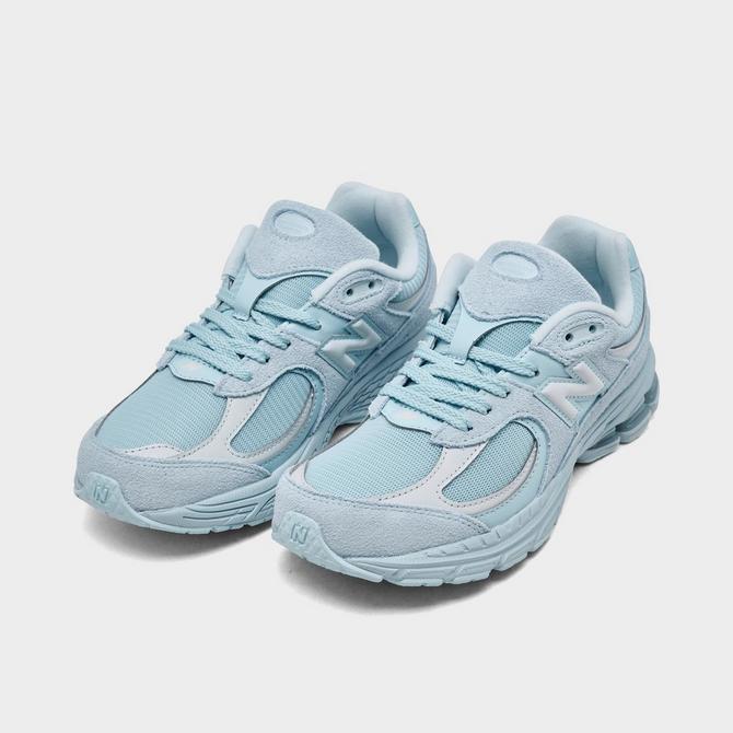 Three Quarter view of Big Kids' New Balance 2002R Casual Shoes in Light Blue Click to zoom