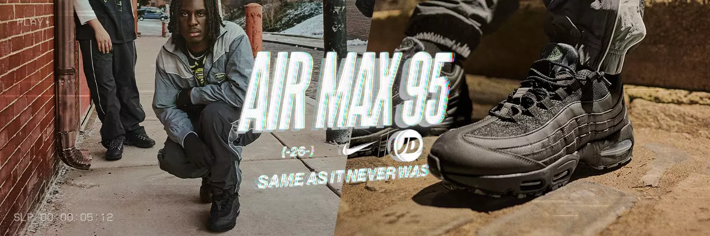 Men's Nike Air Max 95 sneakers in triple black. Side profile view on concrete, featuring layered leather panels and visible Air Max cushioning.