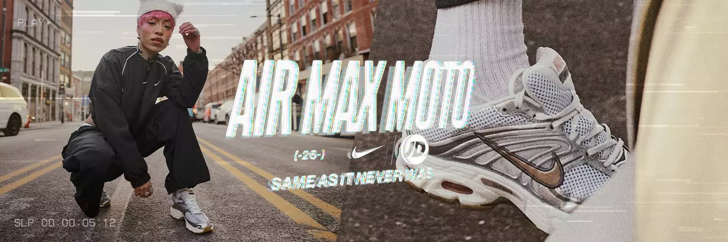 Women’s Nike Air Max Moto sneakers in silver and white. Features breathable mesh uppers, metallic bronze swoosh, and visible Air cushioning units.